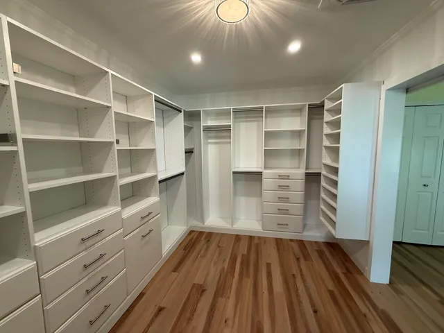 a view of walk in closet with empty racks