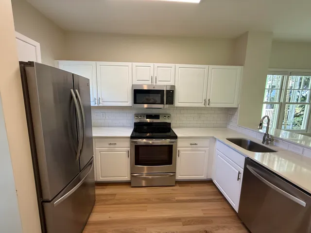 a kitchen with a refrigerator stove and sink