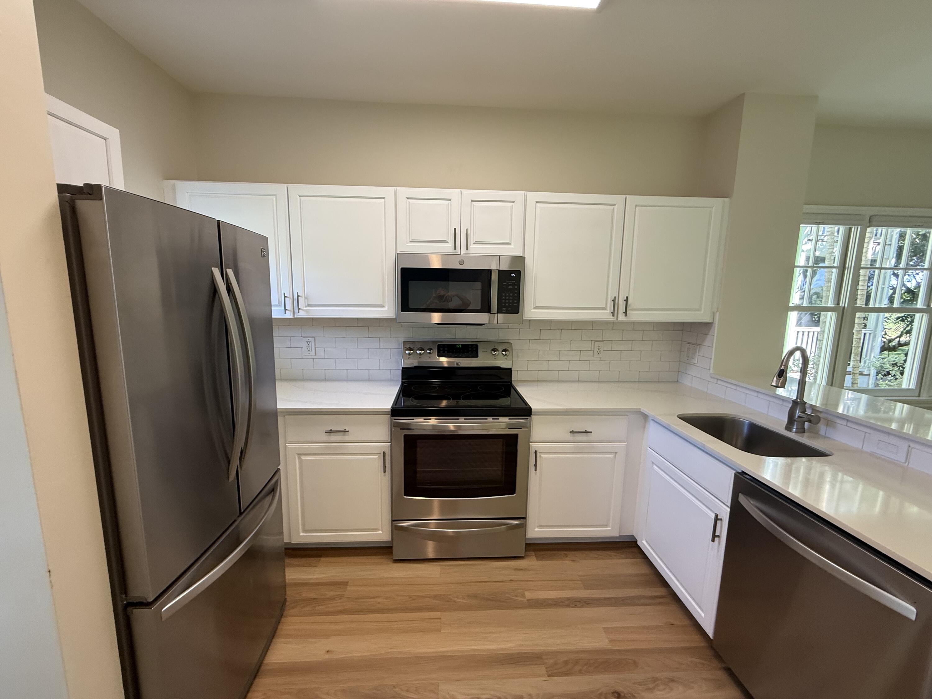 53 Spoonbill Way Key West, FL 33040 - Photo 8 of 32 a kitchen with a refrigerator stove and sink