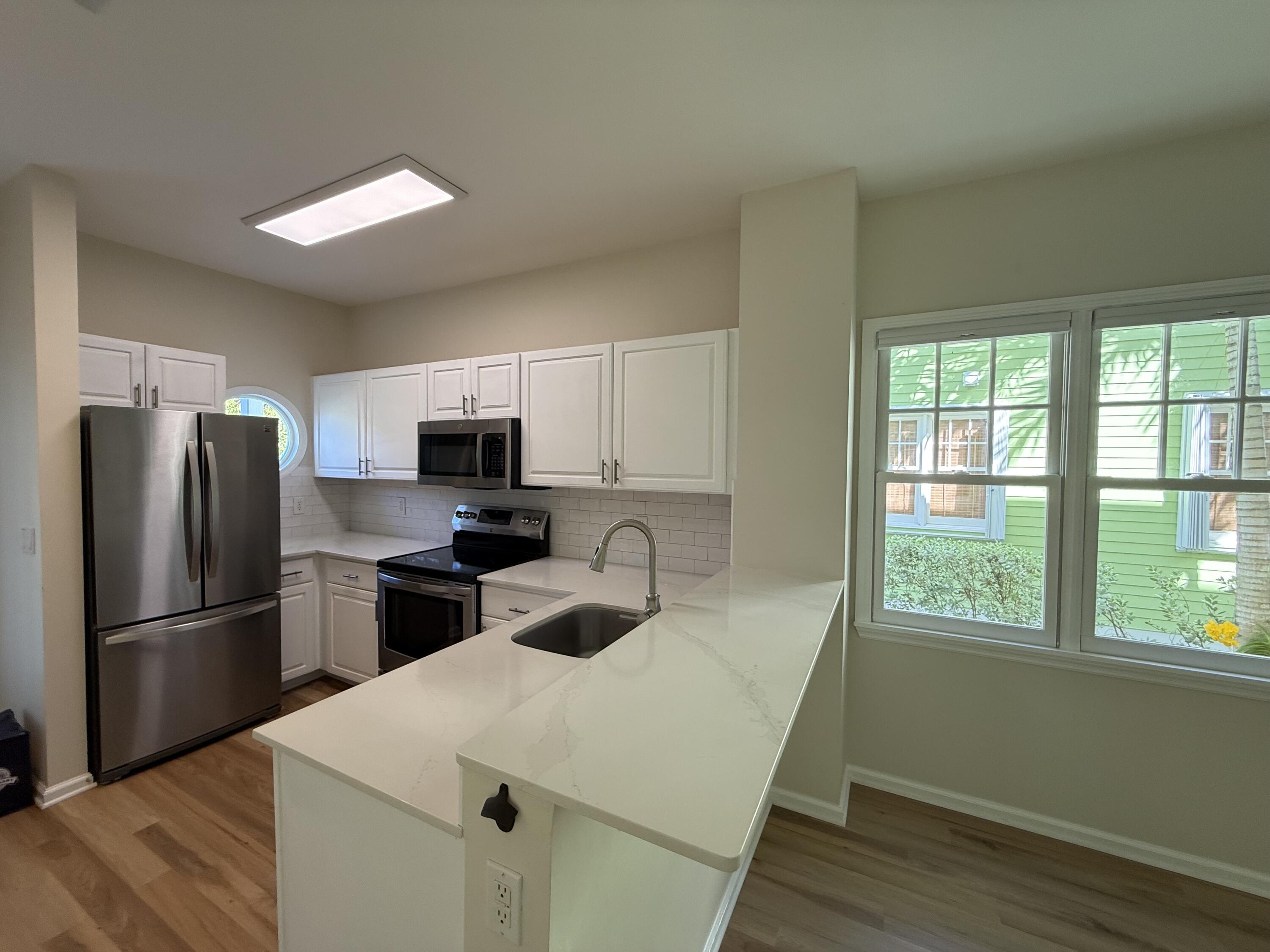 53 Spoonbill Way Key West, FL 33040 - Photo 10 of 32 a kitchen with appliances a sink and a refrigerator