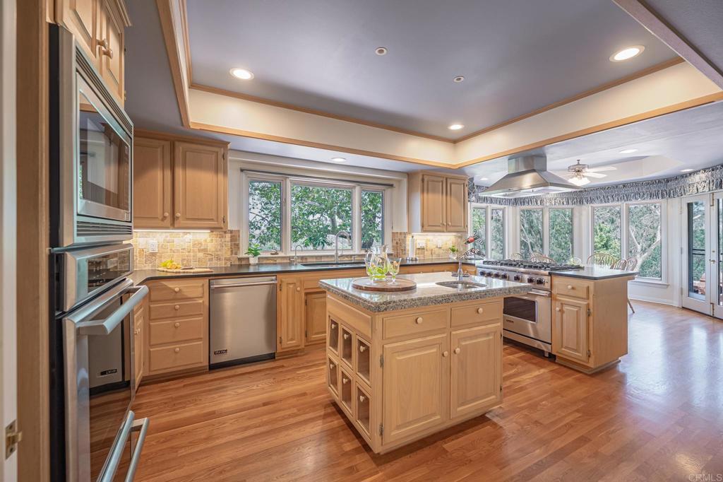 145 Yucca Road Fallbrook, CA 92028 - Photo 13 of 58 a kitchen with stainless steel appliances granite countertop a stove and cabinets