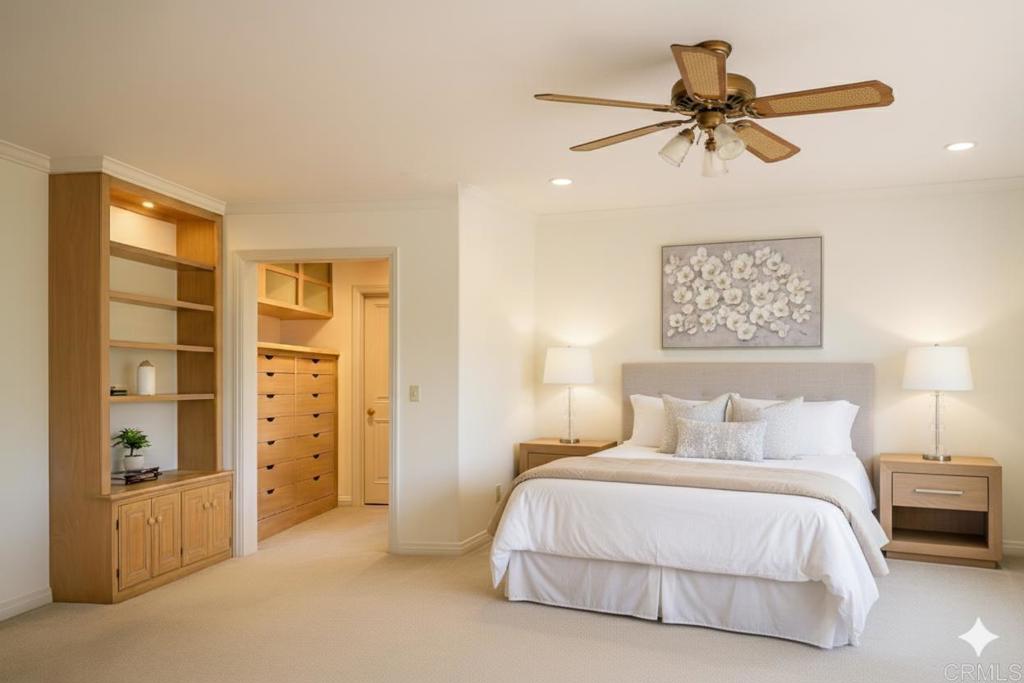 145 Yucca Road Fallbrook, CA 92028 - Photo 24 of 58 a bedroom with a large bed and a chandelier