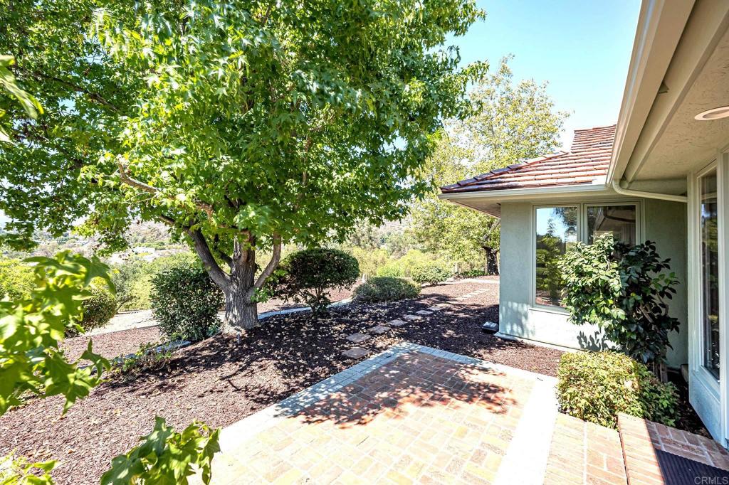 145 Yucca Road Fallbrook, CA 92028 - Photo 42 of 58 a view of a house with a small yard plants and large tree