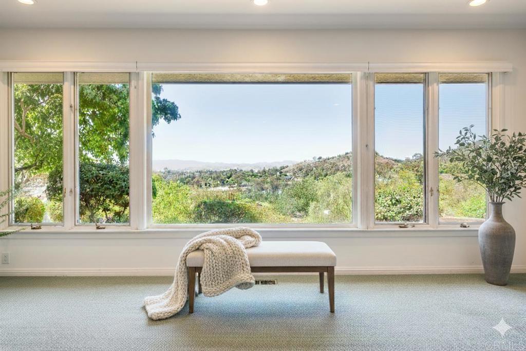 145 Yucca Road Fallbrook, CA 92028 - Photo 10 of 58 a room with a large window and a chair