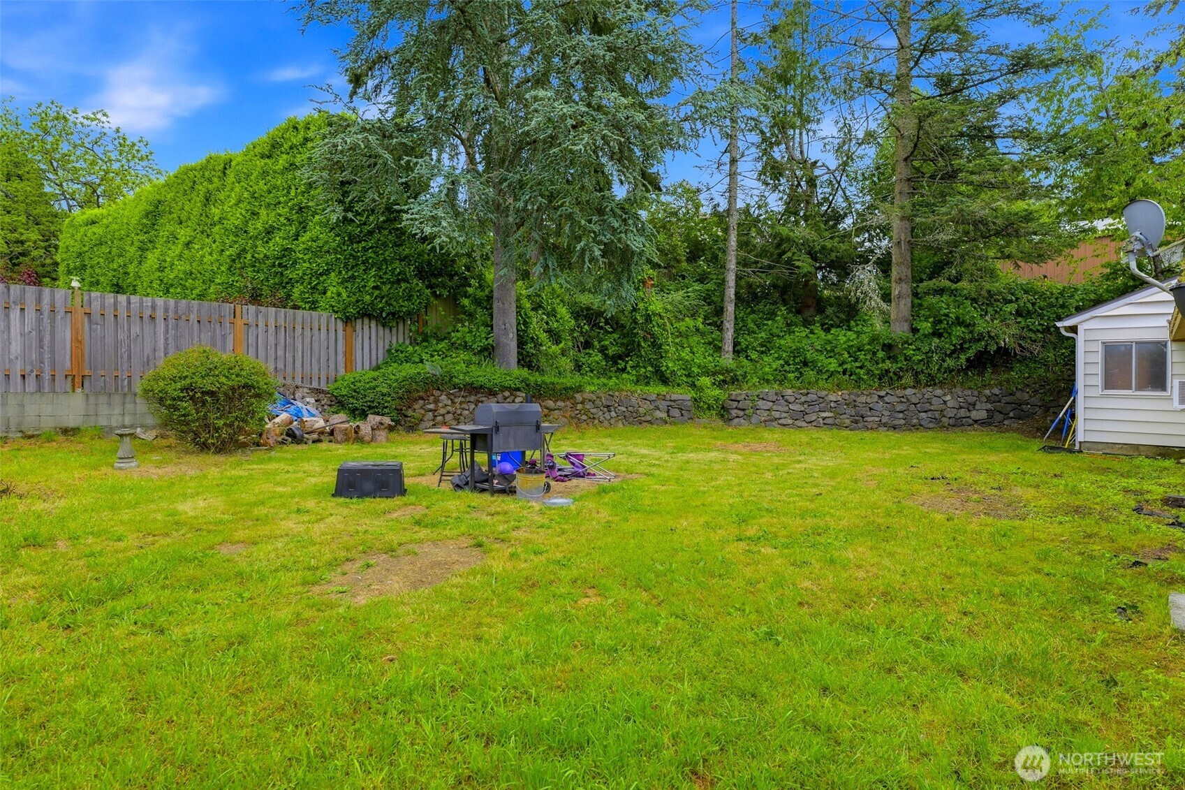 1104 Dibb Street Bremerton, WA 98310 - Photo 12 of 15 a view of a backyard with plants and wooden fence