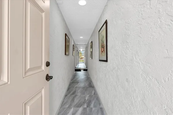 a view of a hallway with paintings on the wall