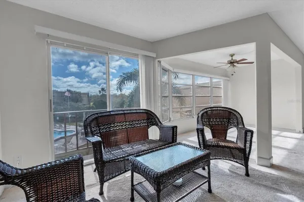 a living room with furniture a rug and a window