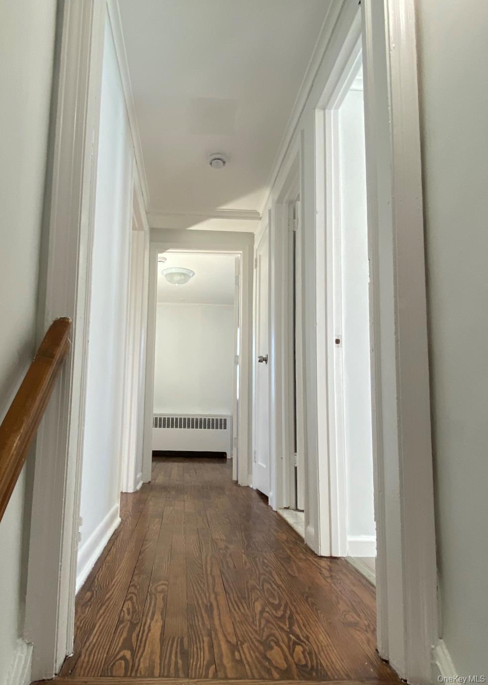 216 Raff Avenue Mineola, NY 11501 - Photo 11 of 20 a view of a hallway with wooden floor and closet