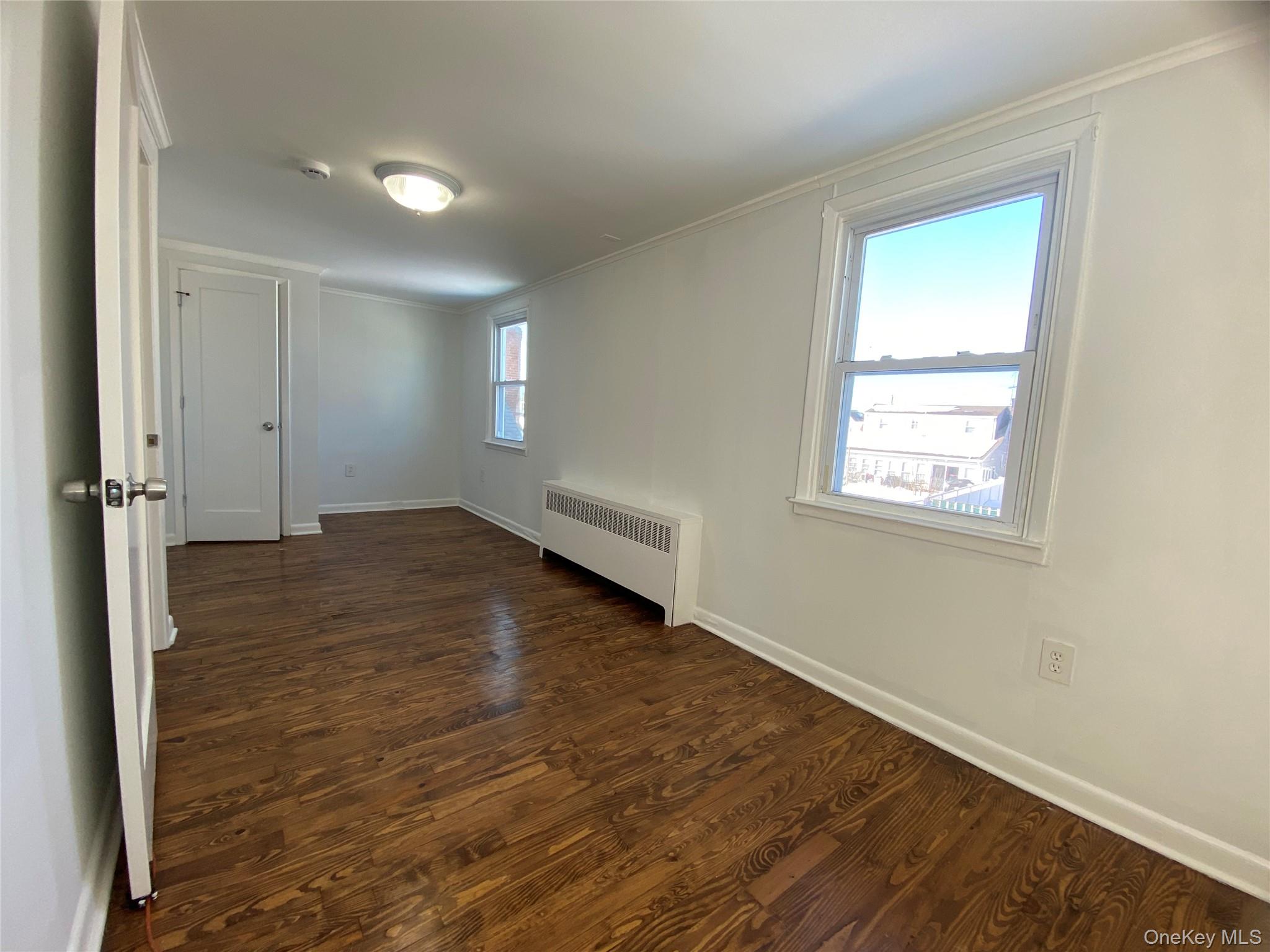 216 Raff Avenue Mineola, NY 11501 - Photo 15 of 20 an empty room with wooden floor and windows
