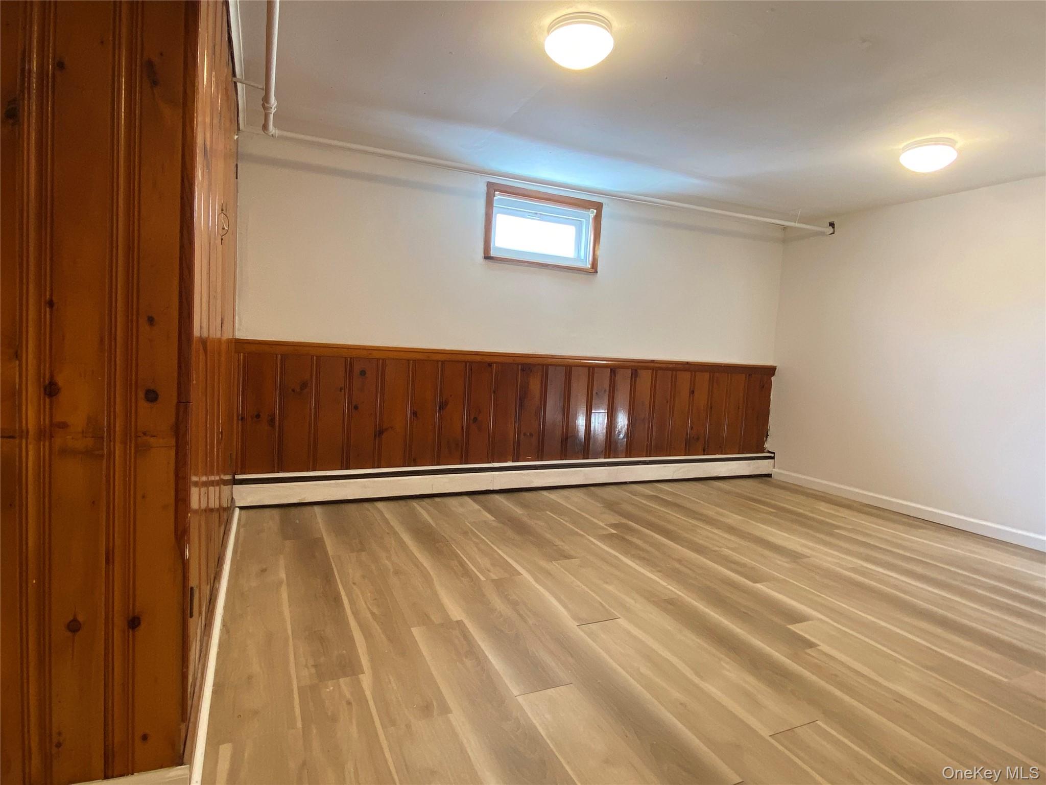 216 Raff Avenue Mineola, NY 11501 - Photo 17 of 20 a view of an empty room with wooden floor
