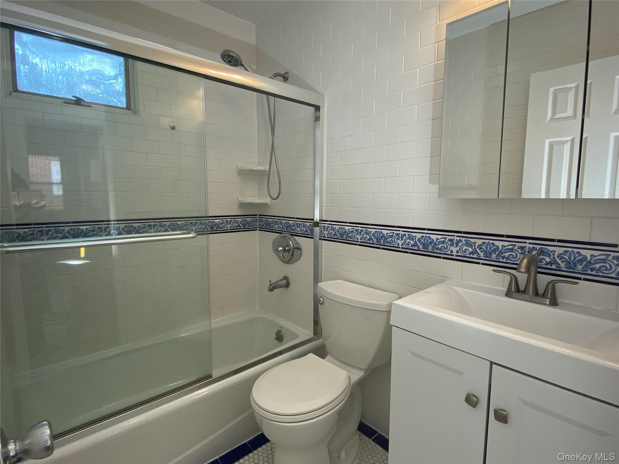 216 Raff Avenue Mineola, NY 11501 - Photo 7 of 20 a bathroom with a toilet a sink and shower