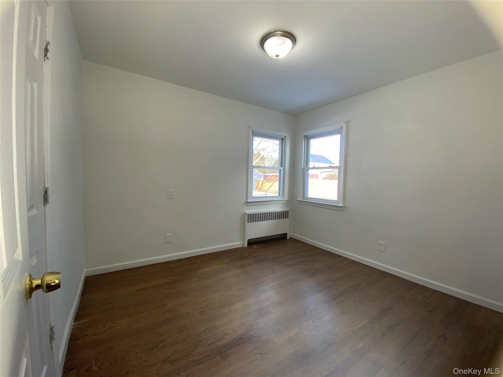 216 Raff Avenue Mineola, NY 11501 - Photo 8 of 20 an empty room with a window