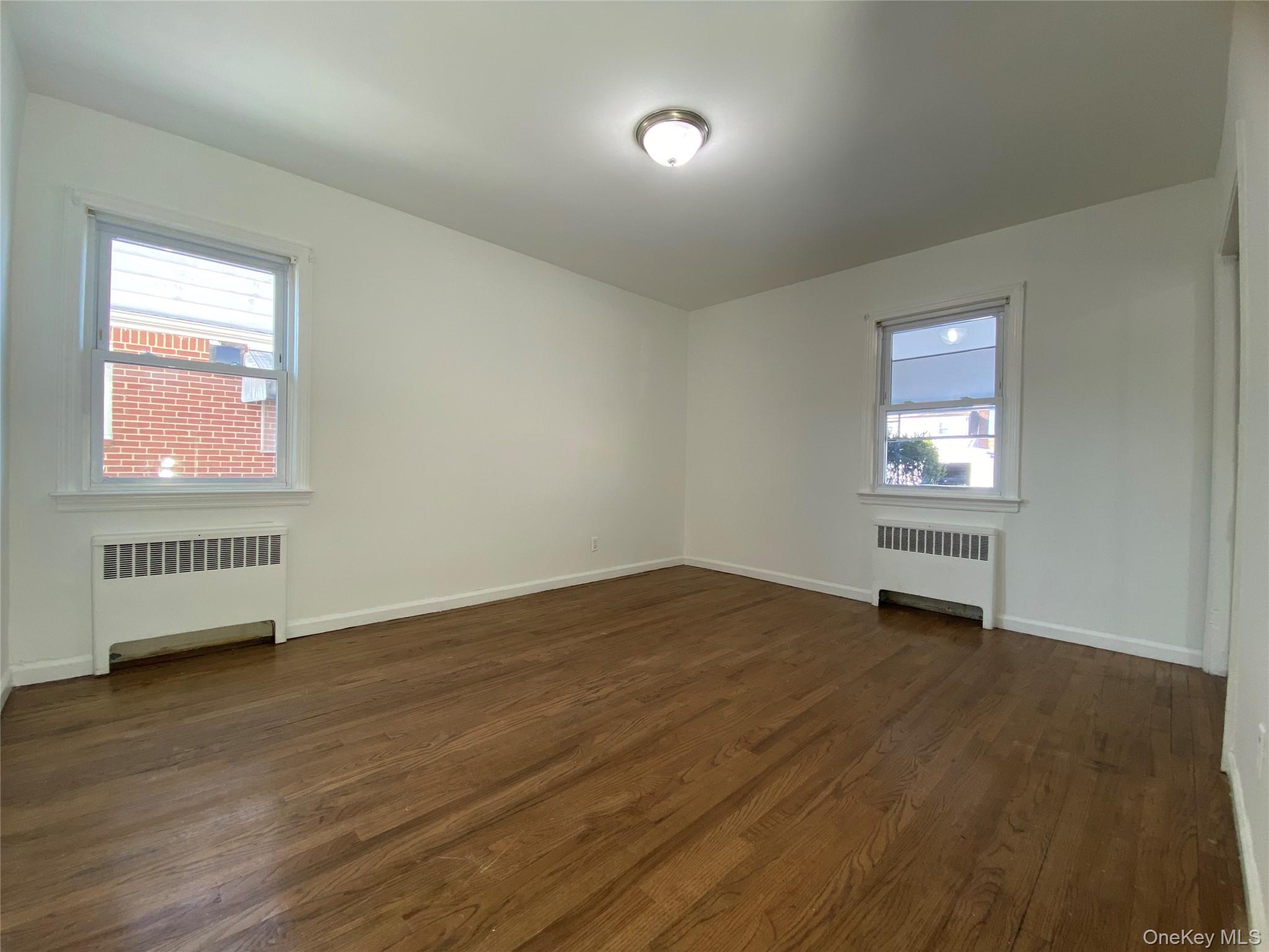 216 Raff Avenue Mineola, NY 11501 - Photo 9 of 20 a view of an empty room and window