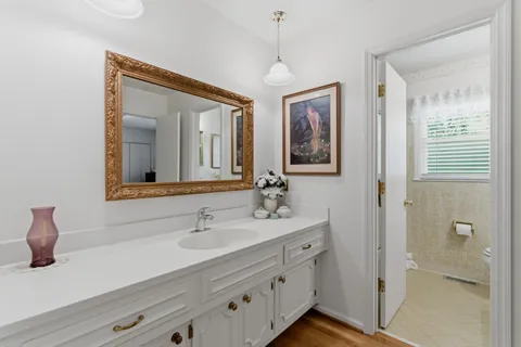 a bathroom with a double vanity sink and a mirror