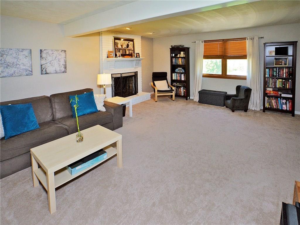 79 Rustic Ridge Drive Pittsburgh, PA 15239 - Photo 2 of 25 Unique and open floor plan with a large family room and possible living room or play room combination with newer neutral carpeting.