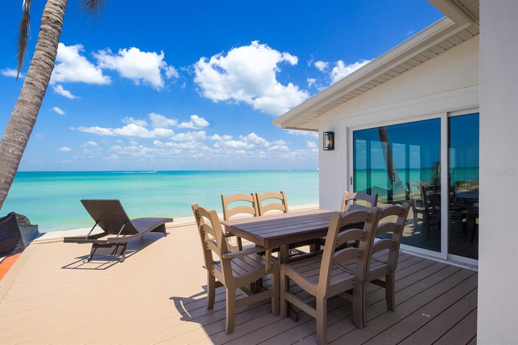 306 South Bay Boulevard Anna Maria, FL 34216 - Photo 6 of 44 a view of a patio with table and chairs and potted plants
