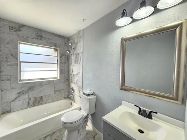 a white toilet sitting next to a shower