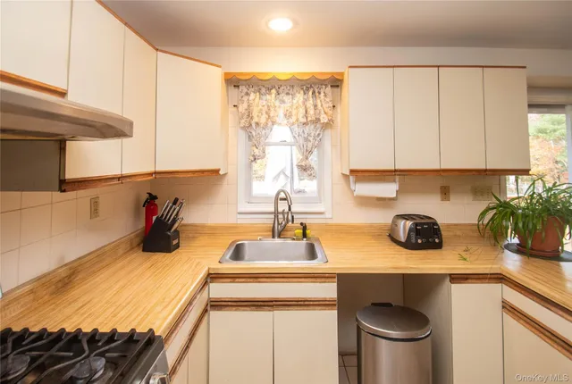 a kitchen with a stove a sink and a cabinets
