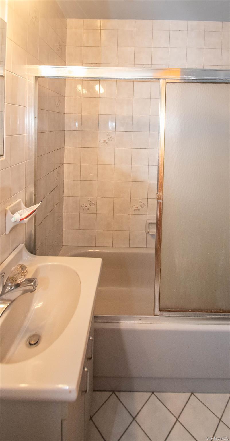 20 Valley Road Forestburgh, NY 12777 - Photo 13 of 38 Bathroom featuring shower / bath combination with glass door, vanity, and tile patterned flooring