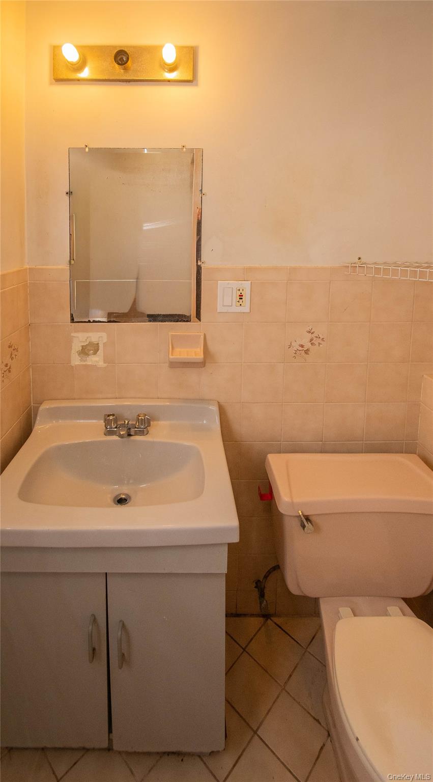 20 Valley Road Forestburgh, NY 12777 - Photo 25 of 38 Bathroom featuring tile patterned flooring, tile walls, vanity, and wainscoting