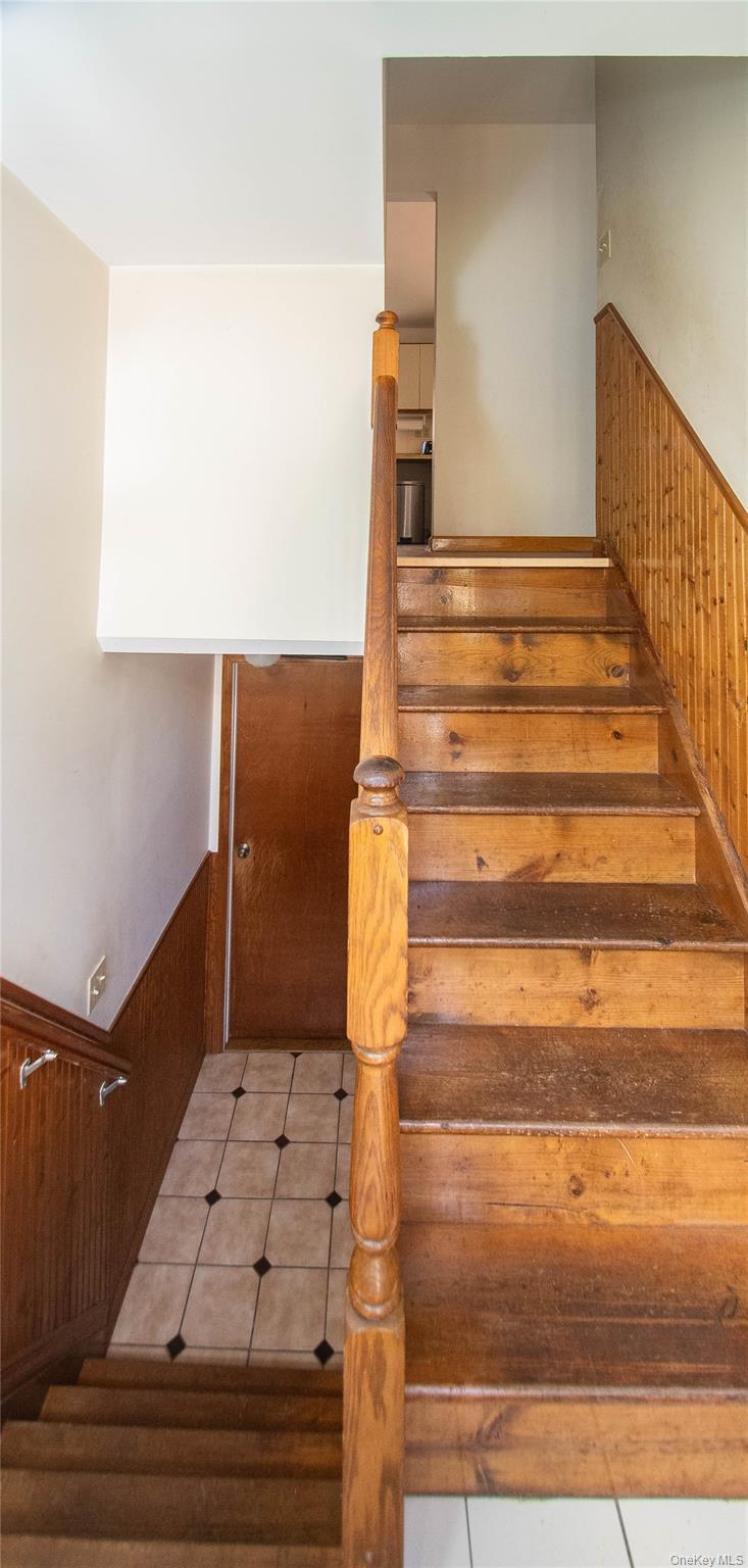 20 Valley Road Forestburgh, NY 12777 - Photo 4 of 38 Staircase with a wainscoted wall, wood walls, and tile patterned floors