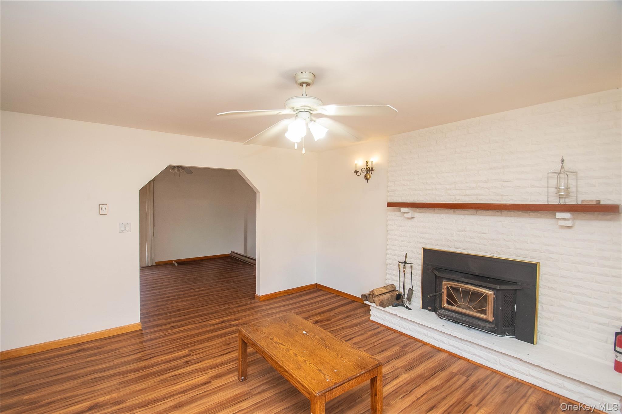 20 Valley Road Forestburgh, NY 12777 - Photo 6 of 38 Unfurnished living room with wood finished floors, arched walkways, and ceiling fan