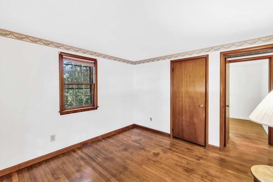 18 Pamet Road West Yarmouth, MA 02673 - Photo 14 of 23 a view of an empty room with wooden floor and a window
