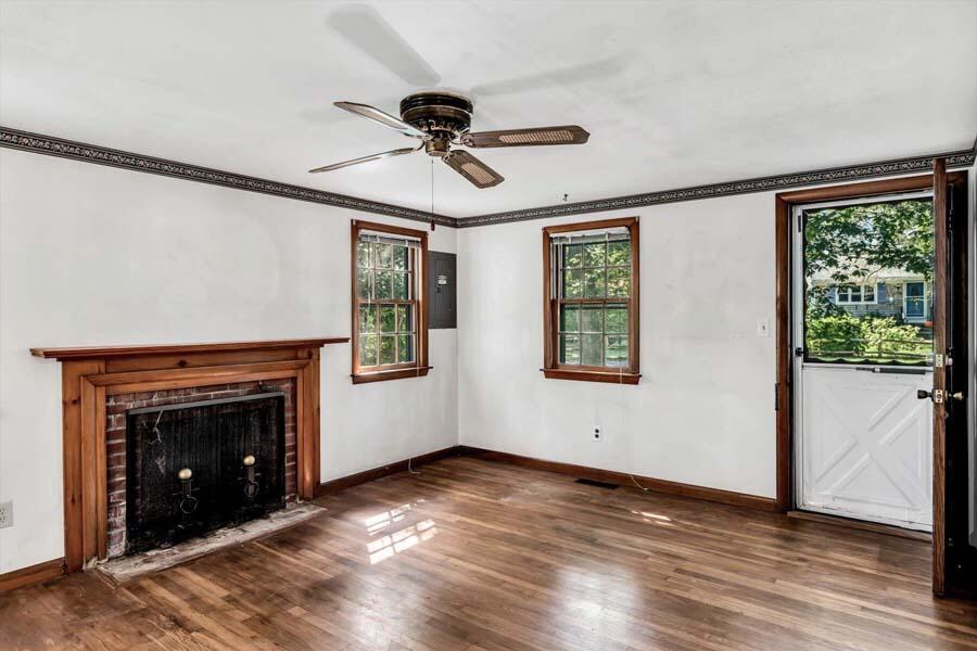 18 Pamet Road West Yarmouth, MA 02673 - Photo 6 of 23 a view of an empty room with wooden floor fireplace and a window