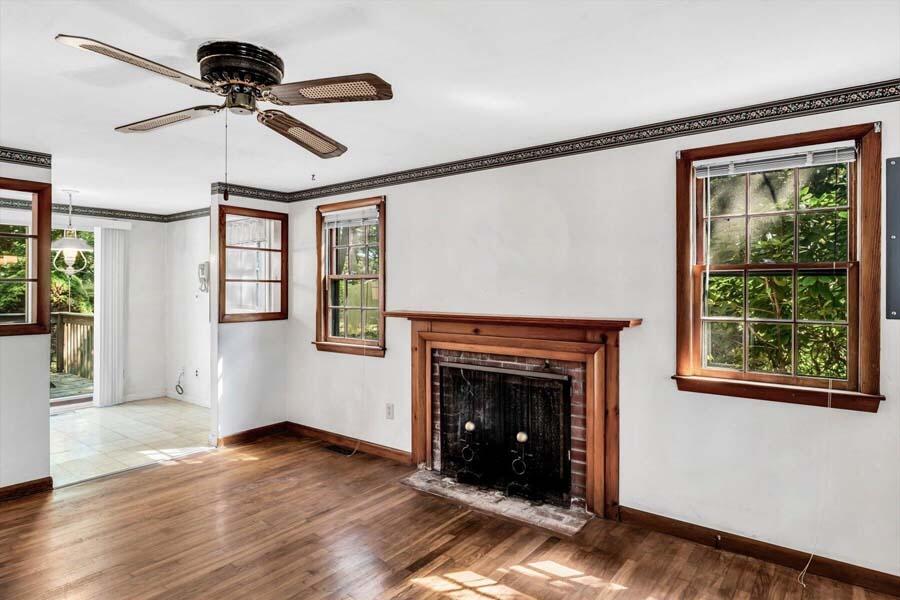 18 Pamet Road West Yarmouth, MA 02673 - Photo 7 of 23 a view of an empty room with wooden floor fireplace and a window