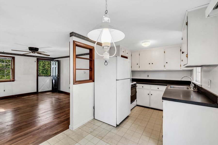 18 Pamet Road West Yarmouth, MA 02673 - Photo 9 of 23 a kitchen with granite countertop a stove a sink and a refrigerator