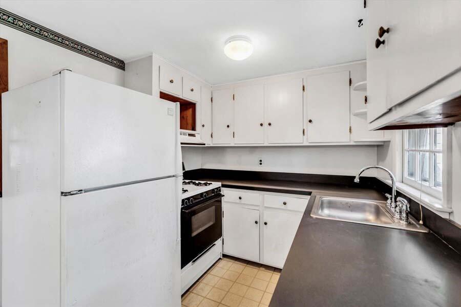 18 Pamet Road West Yarmouth, MA 02673 - Photo 10 of 23 a white refrigerator freezer sitting inside of a kitchen