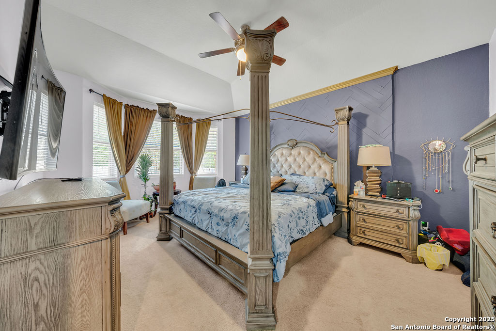 10222 Shawnee Converse, TX 78109 - Photo 12 of 28 a bedroom with a bed and a chandelier