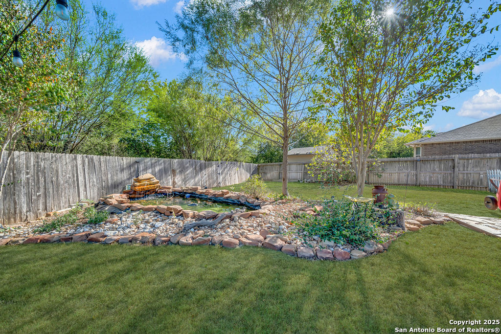 10222 Shawnee Converse, TX 78109 - Photo 27 of 28 a view of backyard with wooden fence and a large tree