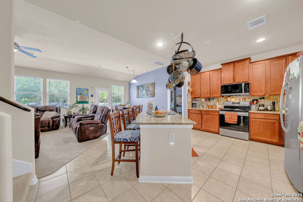 10222 Shawnee Converse, TX 78109 - Photo 7 of 28 a living room with stainless steel appliances kitchen island granite countertop furniture and a view of kitchen