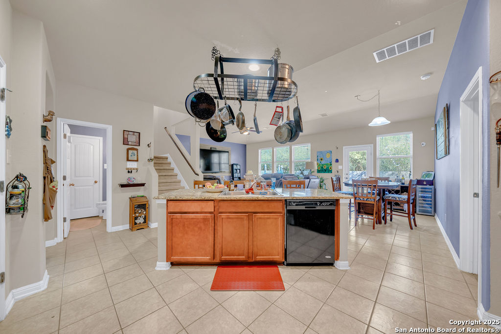 10222 Shawnee Converse, TX 78109 - Photo 8 of 28 a kitchen with stainless steel appliances kitchen island granite countertop a stove a sink a dining table and chairs in it