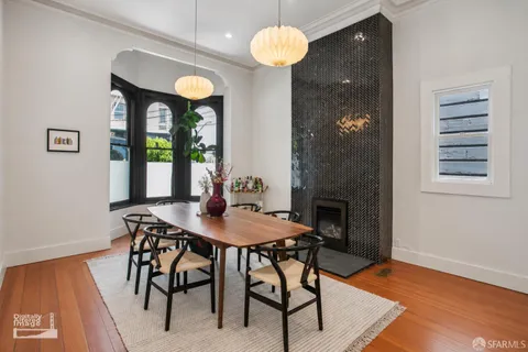 a view of a dining room with furniture and wooden floor