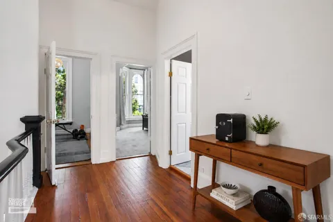 a view of a workspace with furniture and wooden floor