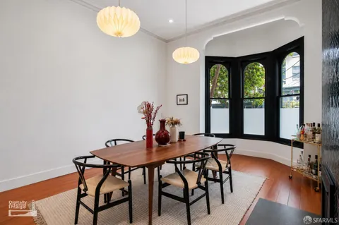 a view of a dining room with furniture and wooden floor