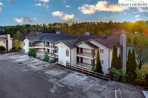 a aerial view of a house with a yard and large tree