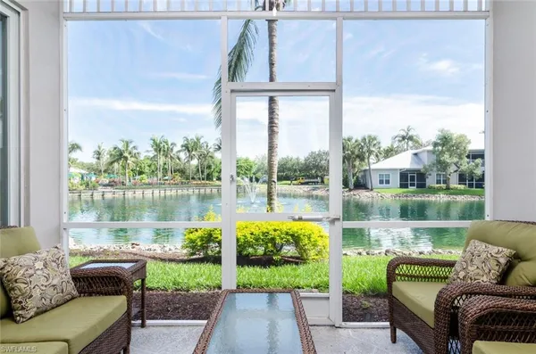 a living room with furniture and a floor to ceiling window