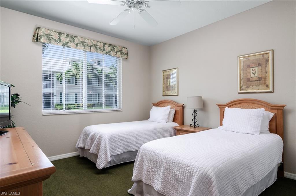 7920 Mahogany Run Lane, Unit 1011 Naples, FL 34113 - Photo 8 of 22 a bedroom with two beds and a large window