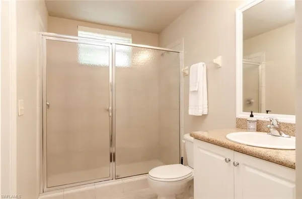 a bathroom with a shower a sink and a toilet