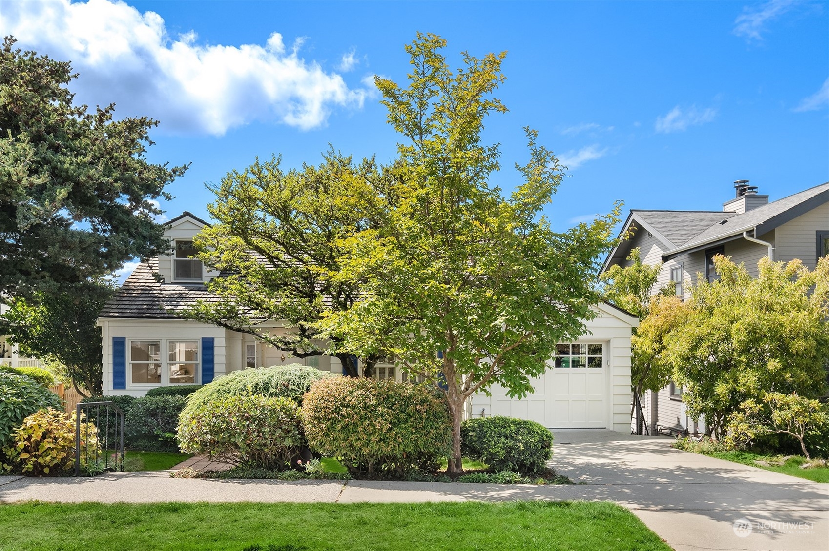 a front view of a house with a yard and fountain