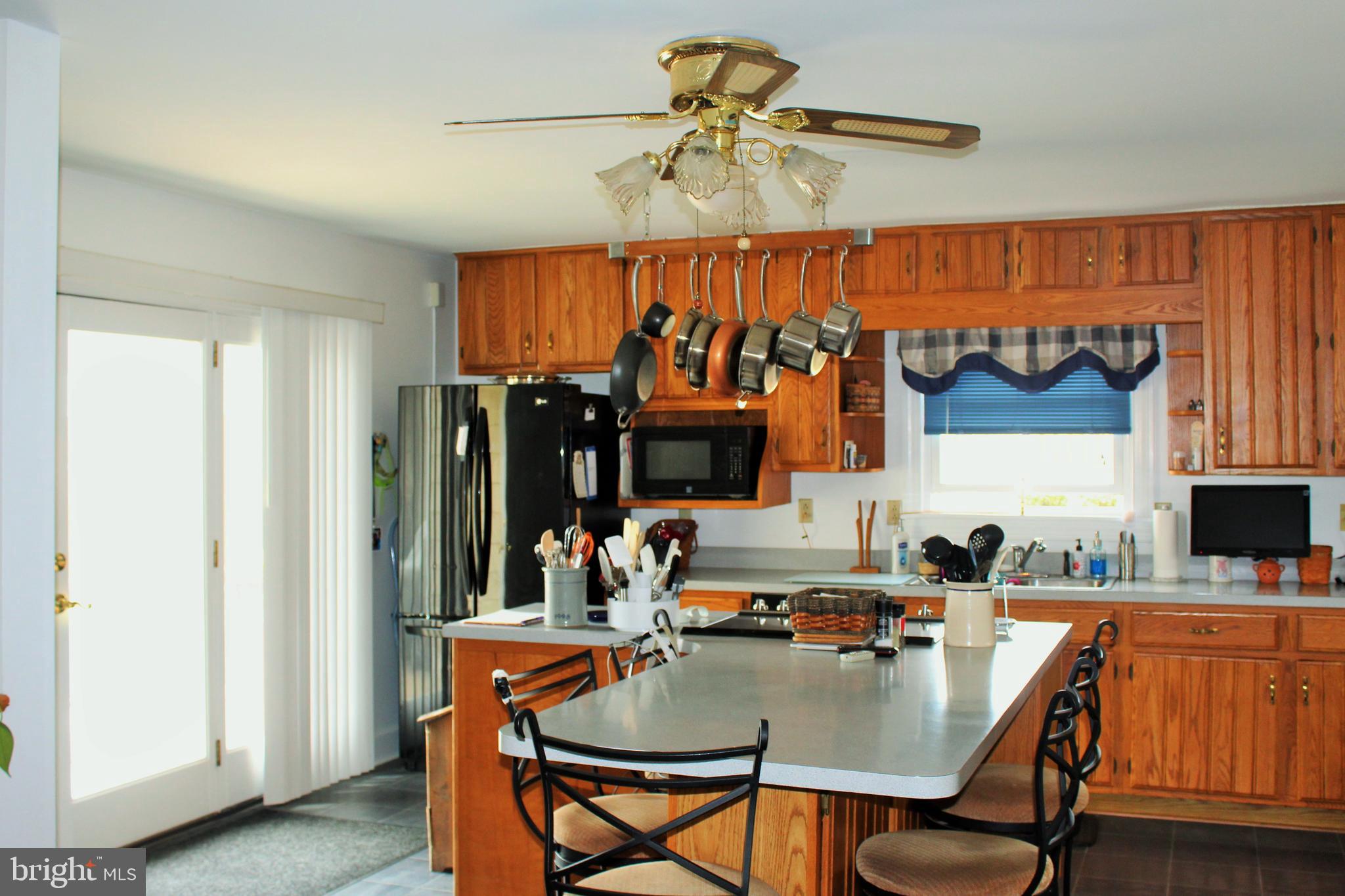 109 East 2nd Avenue Ranson, WV 25438 - Photo 12 of 31 Eat-in kitchen has island and ceiling fan