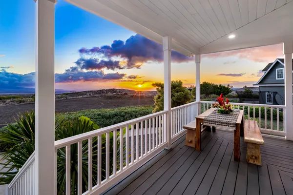 a view of balcony with wooden floor and outdoor seating