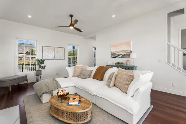 a living room with furniture a rug and a table