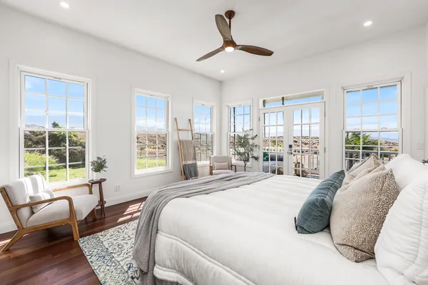 a spacious bedroom with a bed and a couch