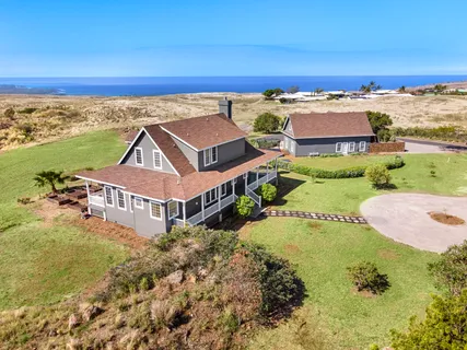 an aerial view of a house with a ocean view