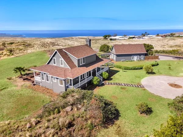 an aerial view of a house with a ocean view