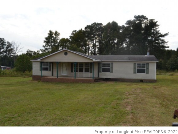 890 Maynard Lake Road Godwin, NC 28344 - Photo 1 of 7 a front view of a house with a garden